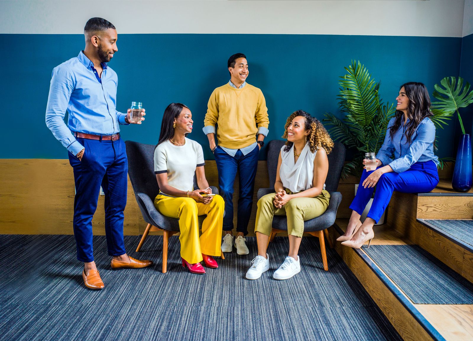 A diverse group of colleagues talking together in a bright office