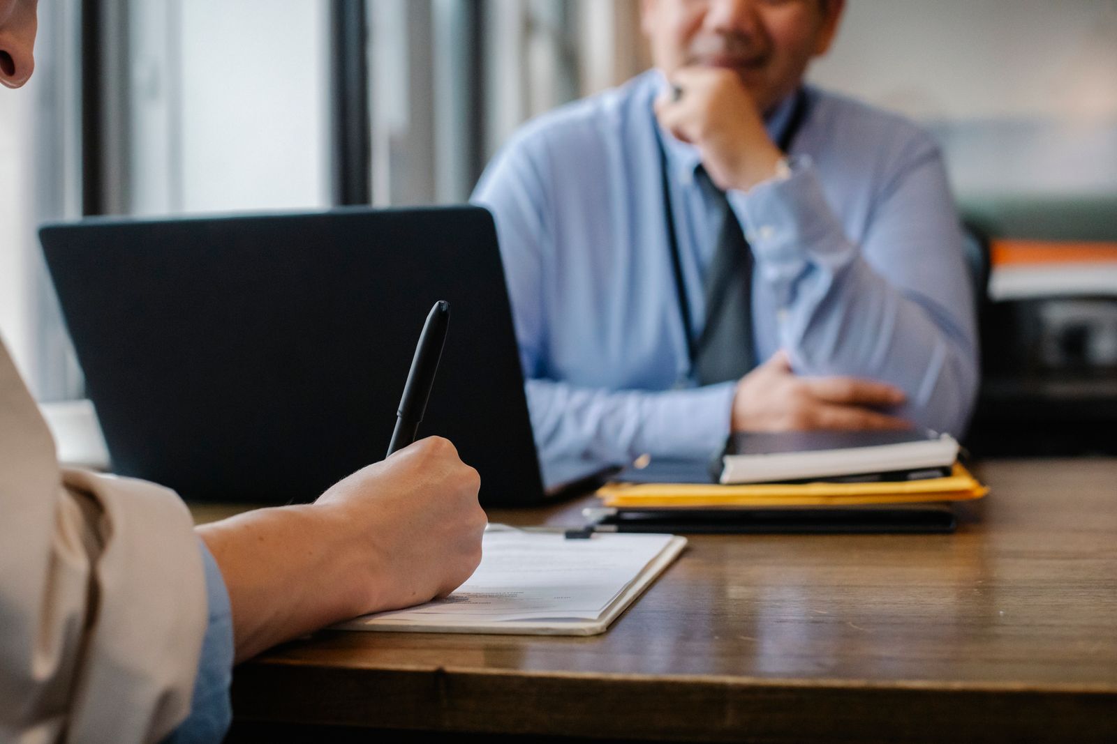 Filling out application forms with a pen during a desk-side consultation