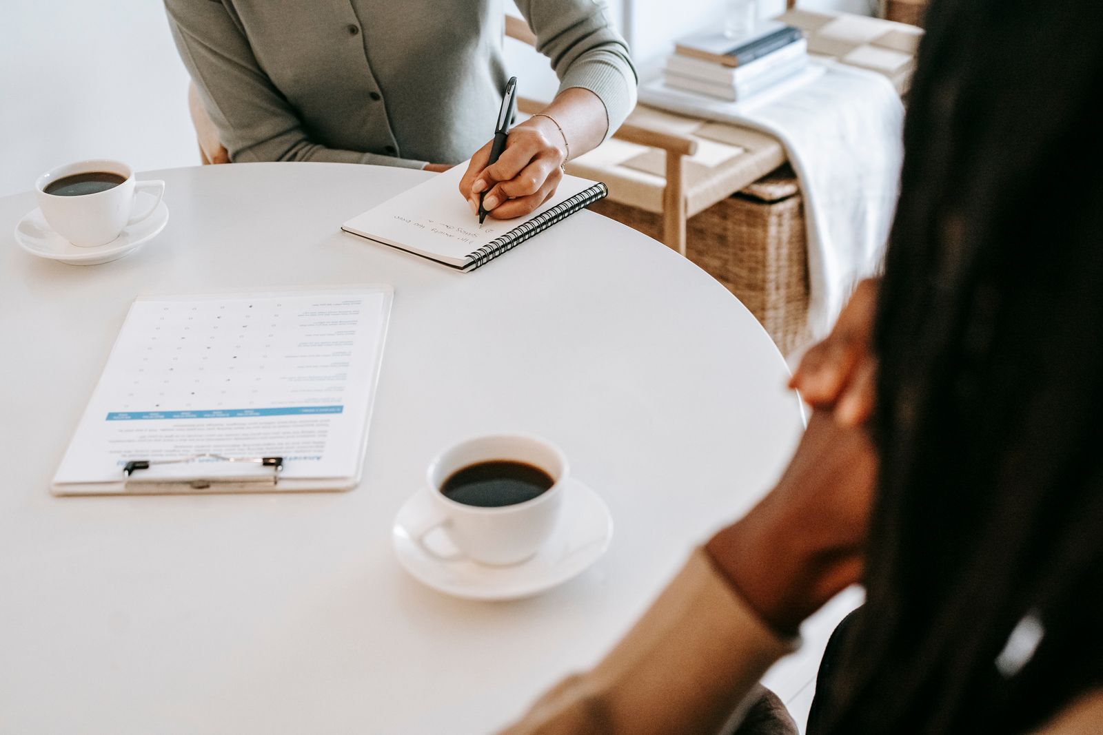 Taking notes during a sit-down conversation over coffee